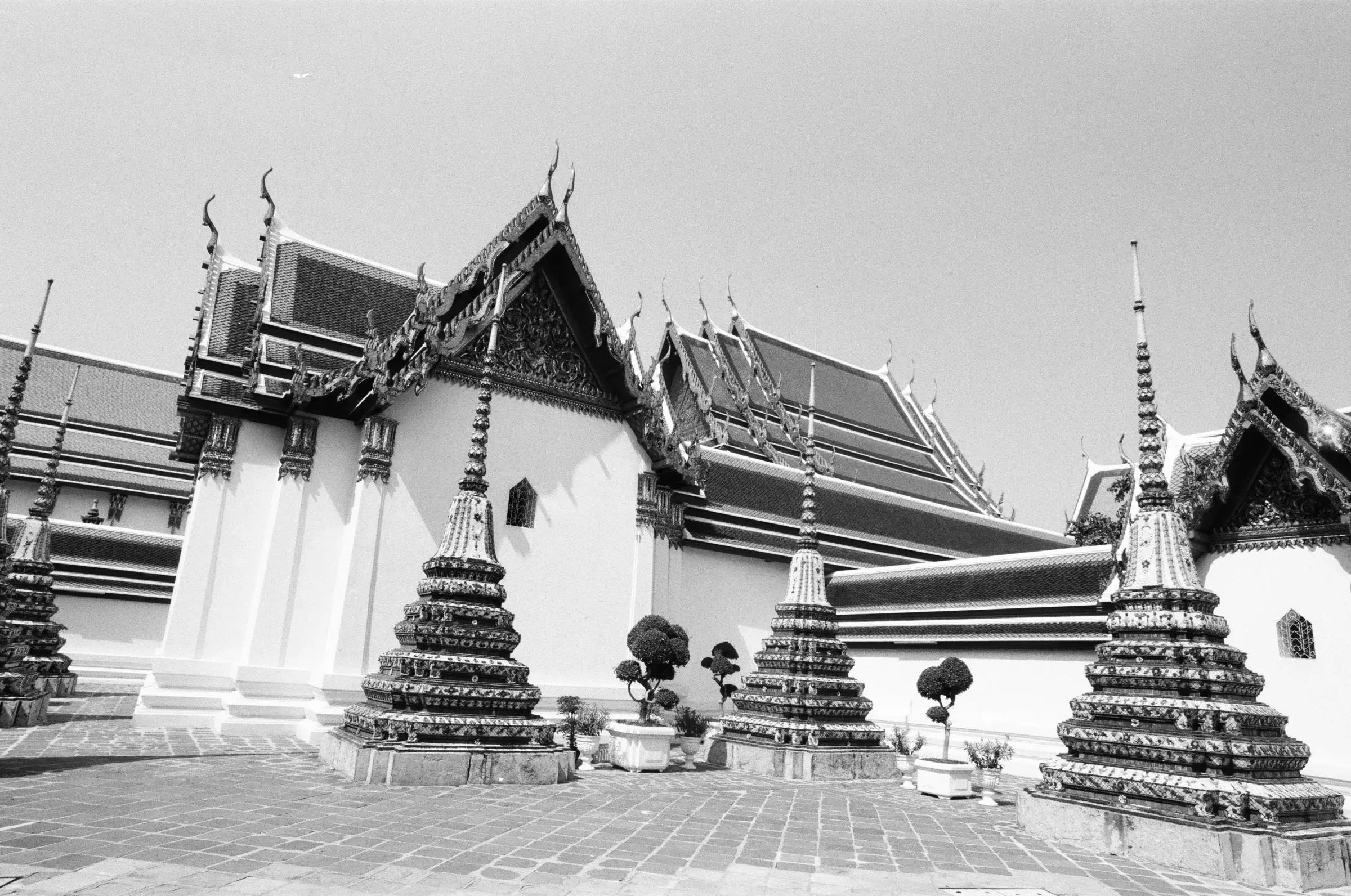 black and white Thai temple complex, ornate spires and stupas crowding the frame